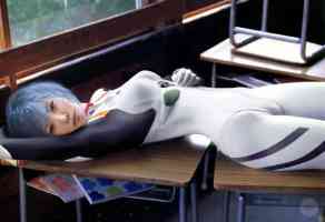 blue haired girl laying across desk