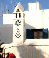 mykonos house chimney marked with magical symbols