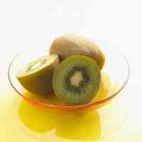 halved and whole kiwi fruits
