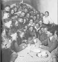 hitler in a coffee shop with loads of fans