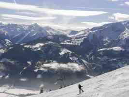 zellamsee snowy mountains and snowboarder