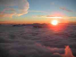 sunset at cloudy mountain peak