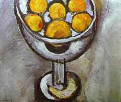 a vase with oranges