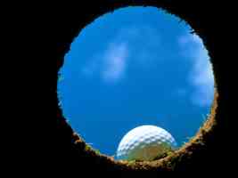 golf ball at lip of hole from inside